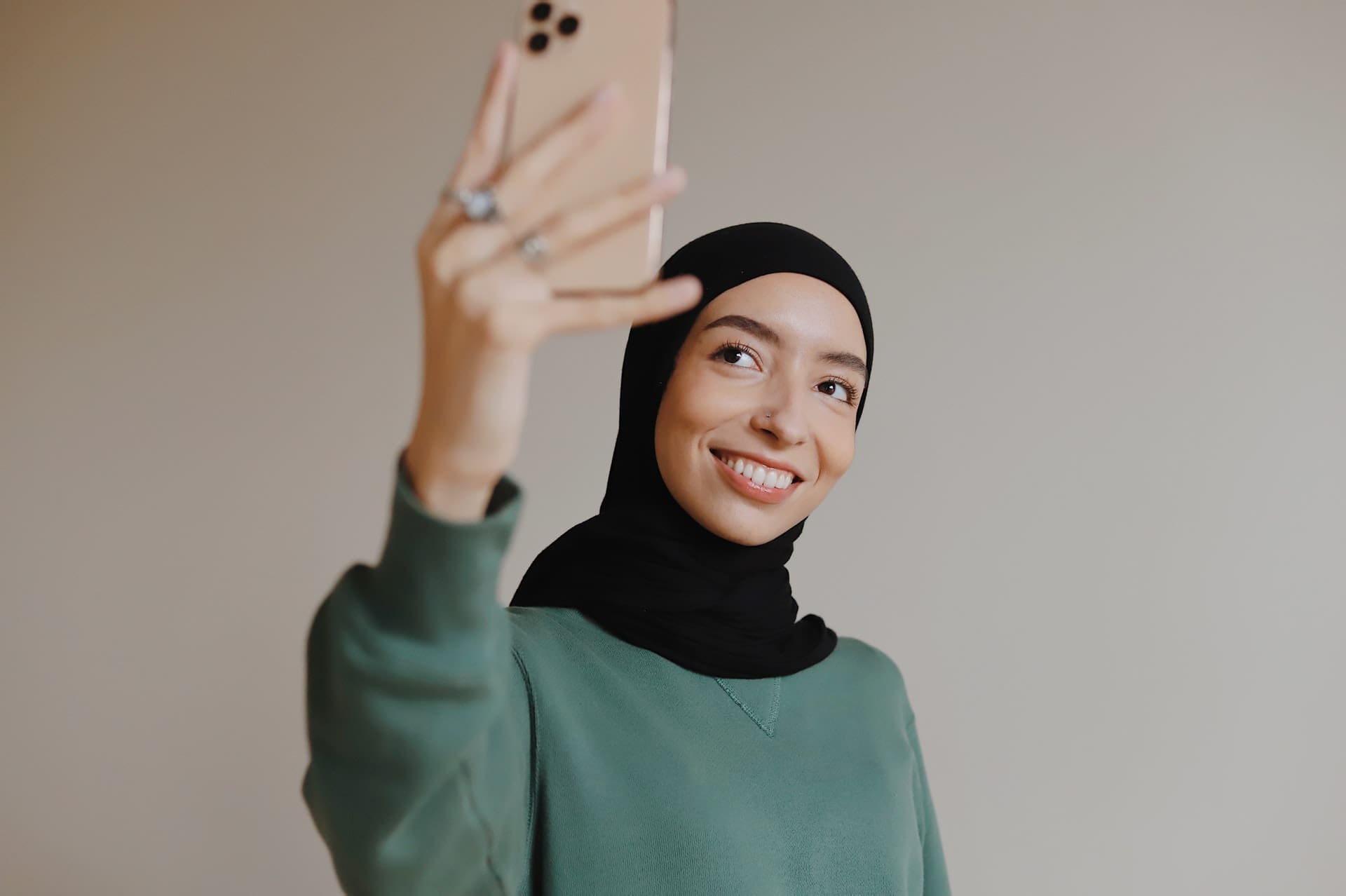 woman smiling and taking a selfie